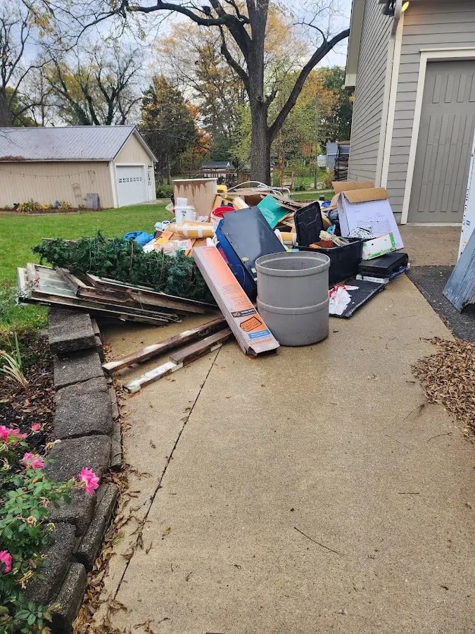 Dumpster being loaded with debris for Residential Dumpster Rental in Hendersonville